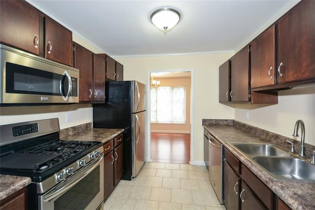 kitchen with dark brown cabinetry, sink, crown molding, and stainless steel appliances