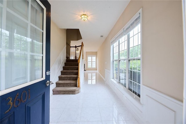 entryway featuring stairs and light tile patterned floors