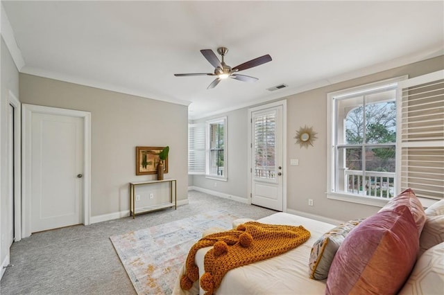 living room featuring crown molding, light colored carpet, ceiling fan, and a wealth of natural light