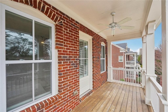 deck with ceiling fan and covered porch