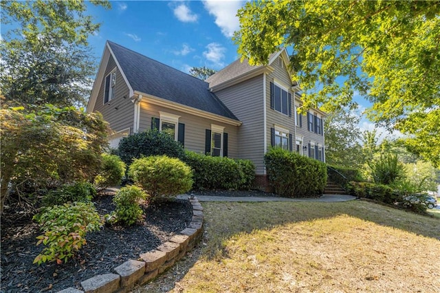 view of side of property featuring a lawn