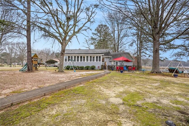 back of property with a playground