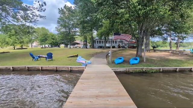 dock area featuring a yard and a water view