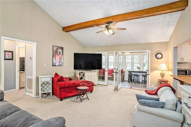 carpeted living area with a textured ceiling, visible vents, ceiling fan, beamed ceiling, and baseboards