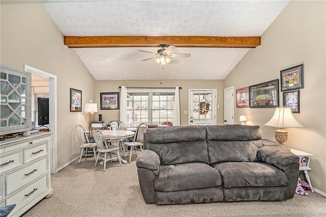 living area with light colored carpet, a ceiling fan, and vaulted ceiling with beams