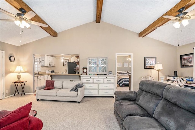 living area with light carpet, a ceiling fan, and beam ceiling