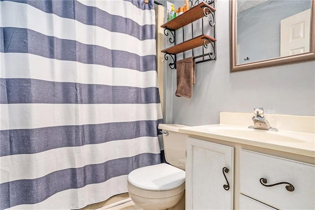 bathroom with curtained shower, vanity, and toilet