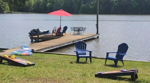 dock area with a wooded view and a water view