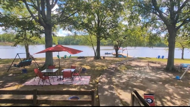 view of yard featuring a water view and fence
