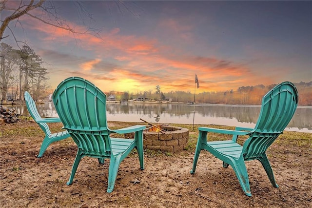surrounding community with a water view and a fire pit