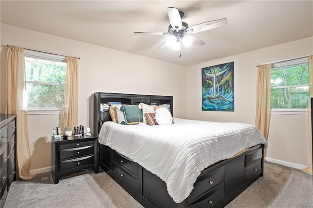 4025 Cheoah Dr, Douglasville, GA 30135 - bedroom featuring light carpet, multiple windows, baseboards, and ceiling fan