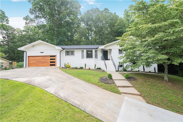 4025 Cheoah Dr, Douglasville, GA 30135 - view of front facade featuring an attached garage, driveway, a front lawn, and view of scattered trees