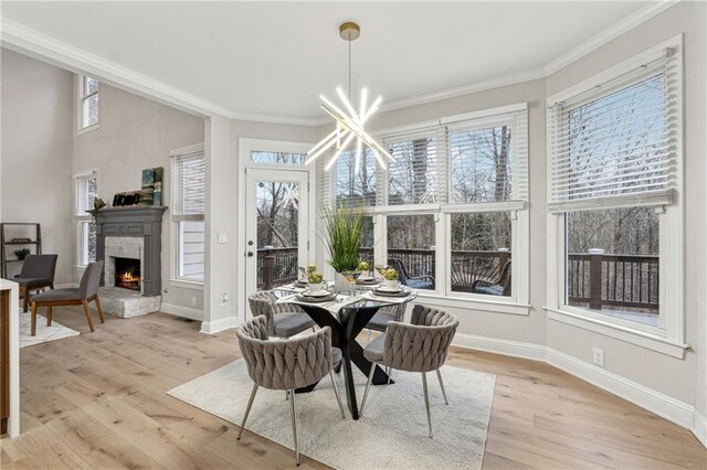 sunroom / solarium featuring a chandelier and a warm lit fireplace