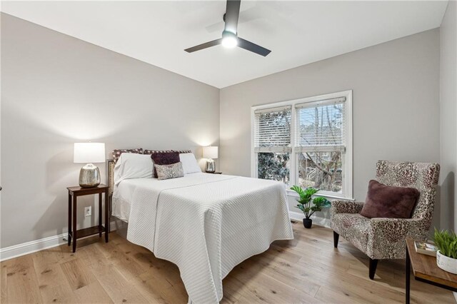 bedroom featuring light wood-style floors, ceiling fan, and baseboards