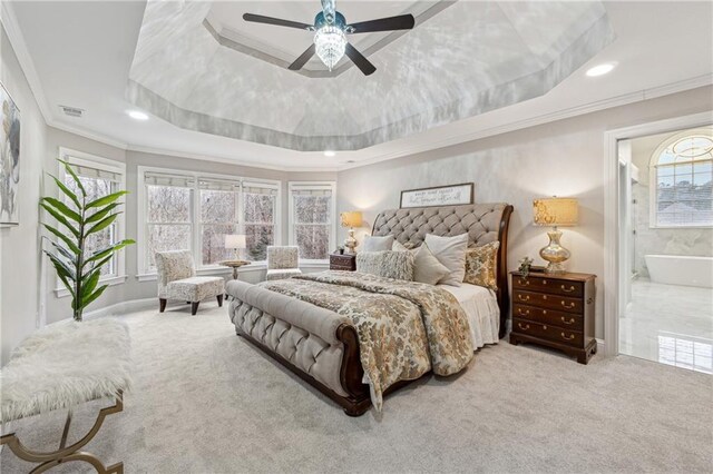 bedroom featuring recessed lighting, light carpet, visible vents, ornamental molding, and a tray ceiling