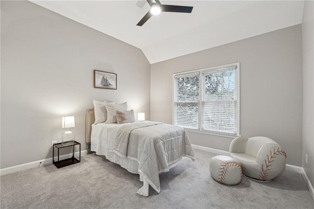 bedroom featuring vaulted ceiling, light carpet, and baseboards