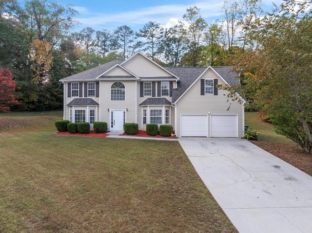 view of front facade featuring an attached garage, concrete driveway, and a front yard