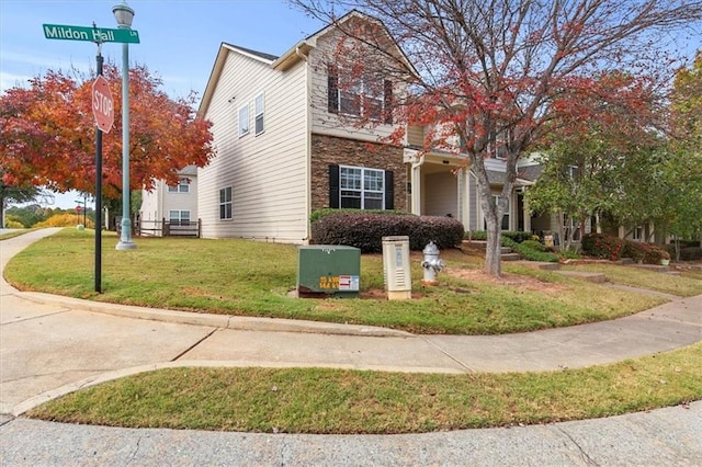 view of side of property with a yard