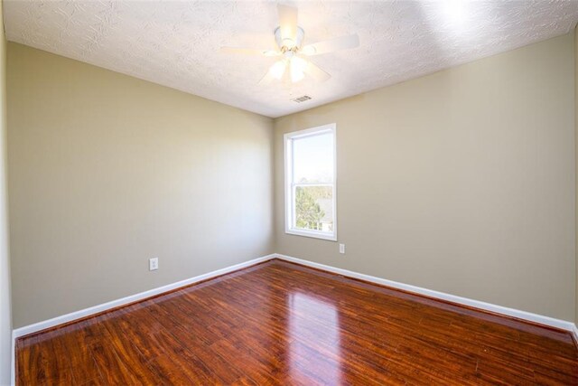 1188 Pine Acre Dr, Sugar Hill, GA 30518 - spare room featuring wood finished floors, baseboards, and a ceiling fan