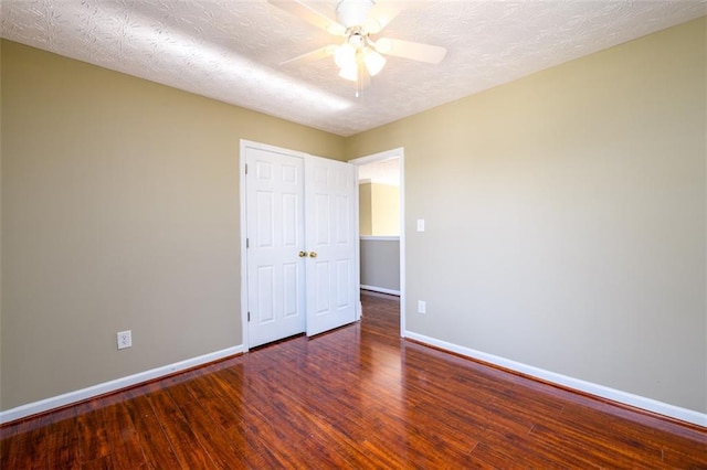 1188 Pine Acre Dr, Sugar Hill, GA 30518 - unfurnished bedroom with baseboards, wood finished floors, and ceiling fan