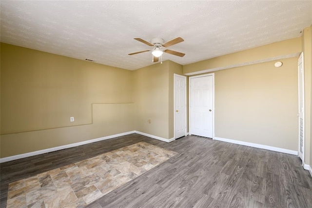 1188 Pine Acre Dr, Sugar Hill, GA 30518 - unfurnished room featuring a ceiling fan, wood finished floors, and baseboards