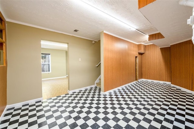 1188 Pine Acre Dr, Sugar Hill, GA 30518 - basement featuring tile patterned floors, wooden walls, ornamental molding, stairs, and baseboards