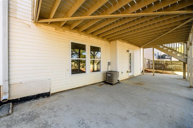 1188 Pine Acre Dr, Sugar Hill, GA 30518 - view of patio / terrace featuring stairway, fence, central AC unit, and an attached carport
