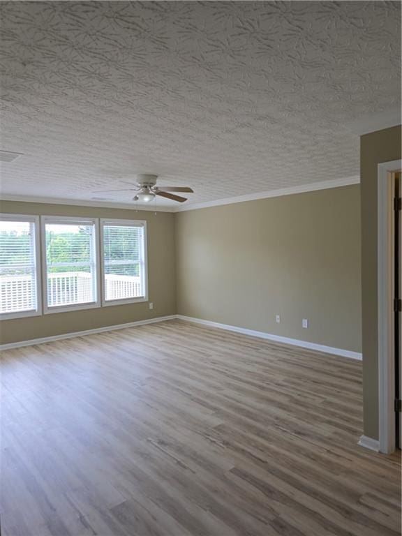 1188 Pine Acre Dr, Sugar Hill, GA 30518 - unfurnished room with a ceiling fan, baseboards, wood finished floors, crown molding, and a textured ceiling