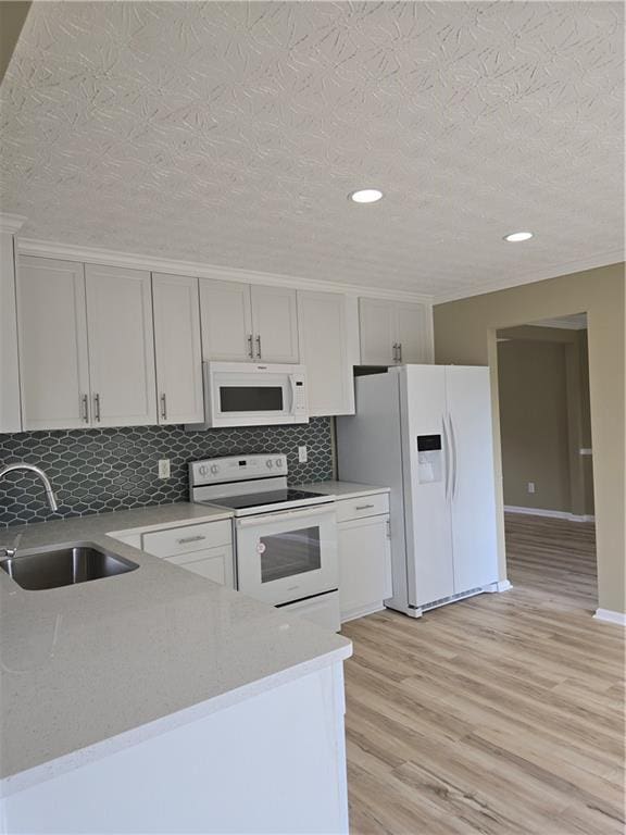 1188 Pine Acre Dr, Sugar Hill, GA 30518 - kitchen featuring white appliances, a sink, light wood-style flooring, decorative backsplash, and recessed lighting