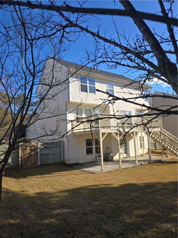 rear view of house featuring a yard and a patio