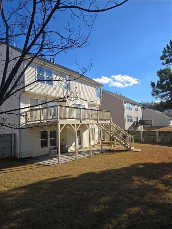 rear view of property featuring a patio, a deck, and a lawn