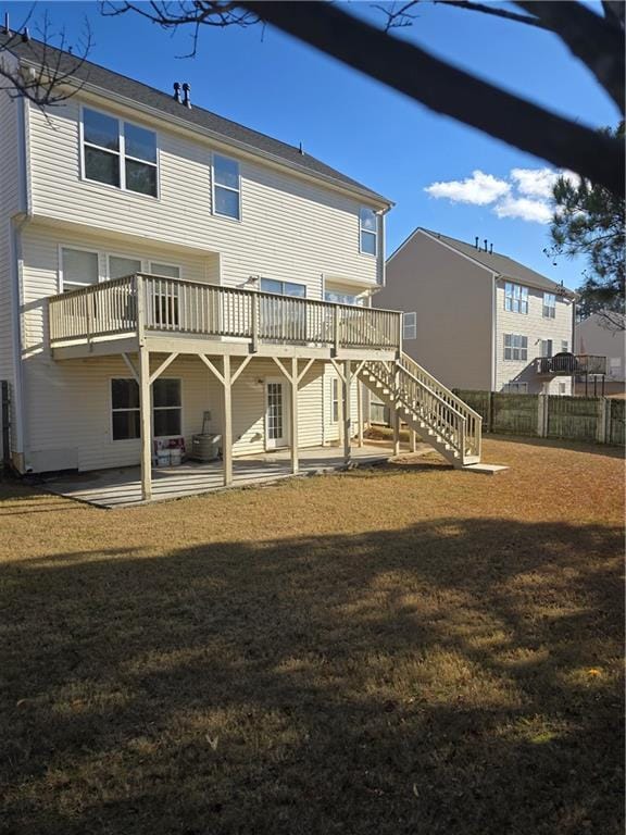 back of house with a lawn, a patio area, and a wooden deck