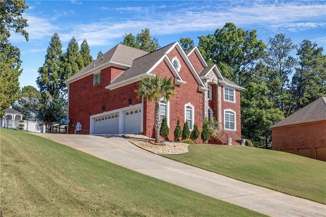 view of front of house featuring a front yard and a garage