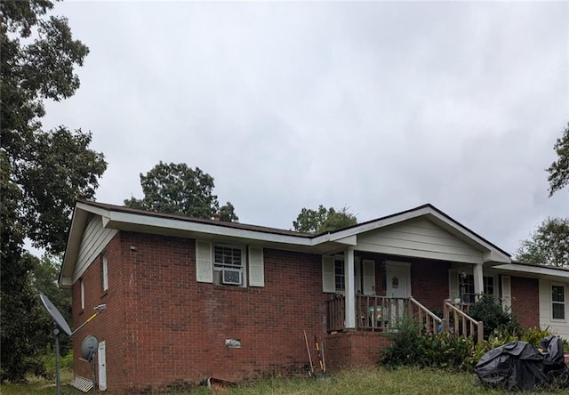 view of front of home featuring cooling unit and covered porch