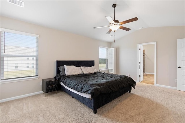 carpeted bedroom featuring lofted ceiling, multiple windows, and ceiling fan