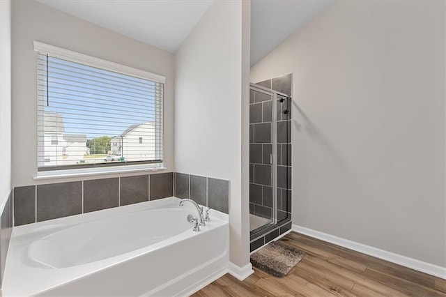 bathroom featuring hardwood / wood-style flooring, lofted ceiling, and separate shower and tub