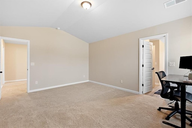 office space with vaulted ceiling and light carpet