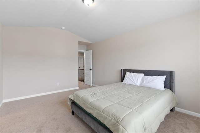 bedroom with light carpet and vaulted ceiling