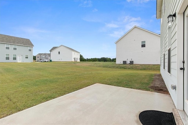 view of yard with central AC and a patio area