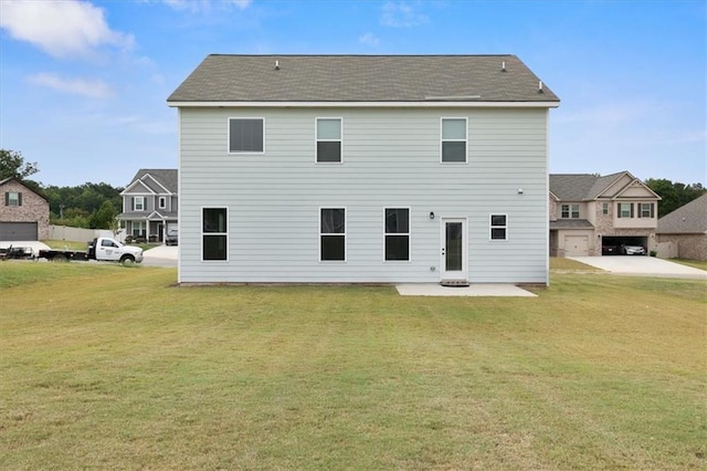 back of house featuring a patio area and a lawn