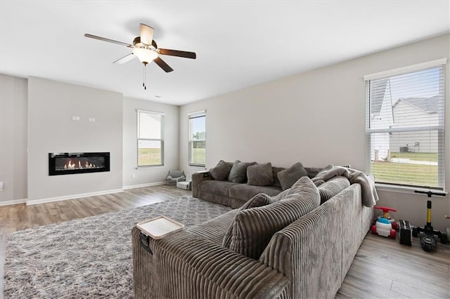 living room featuring light hardwood / wood-style flooring and ceiling fan