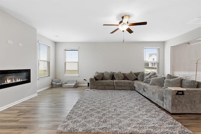 living room with dark hardwood / wood-style floors and ceiling fan