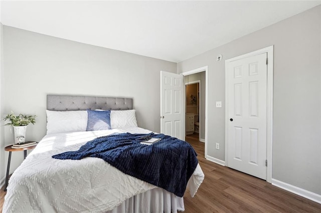 bedroom with dark hardwood / wood-style floors