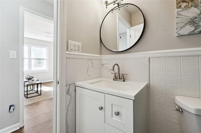 bathroom featuring toilet, hardwood / wood-style flooring, and vanity