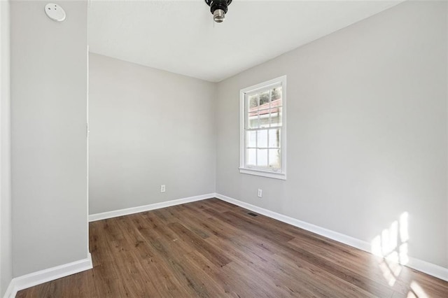 spare room featuring dark hardwood / wood-style flooring