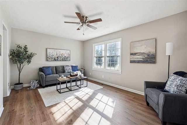 living room featuring ceiling fan and hardwood / wood-style floors