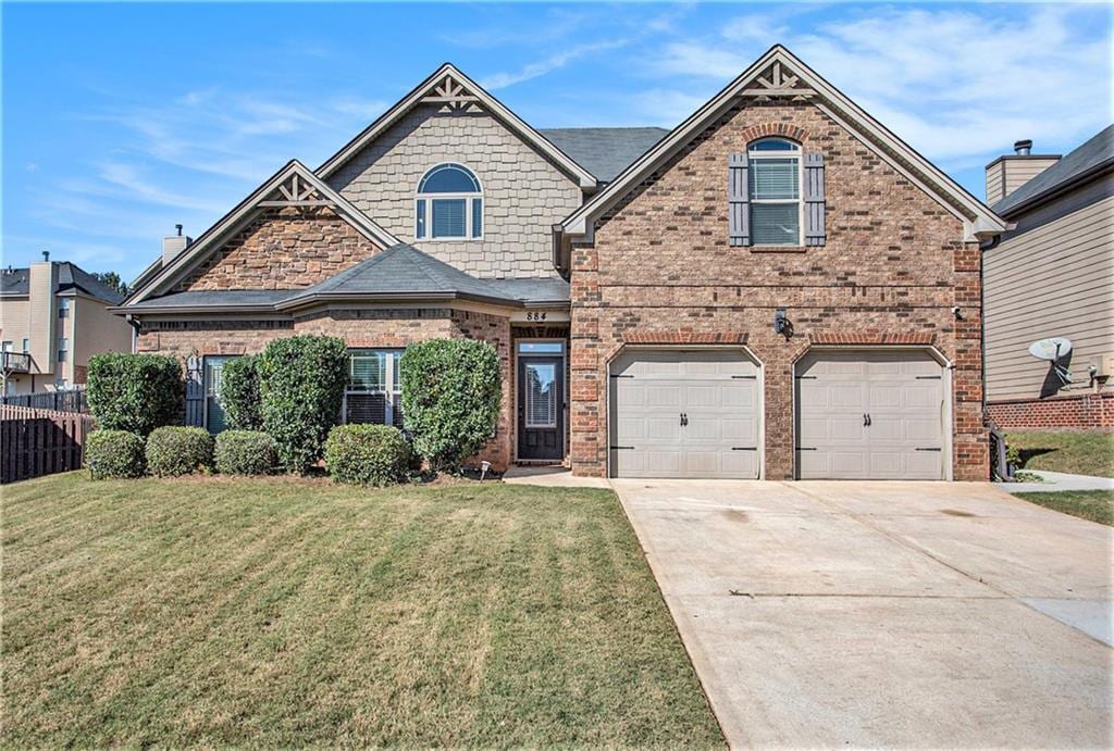 view of front of home featuring a garage and a front yard