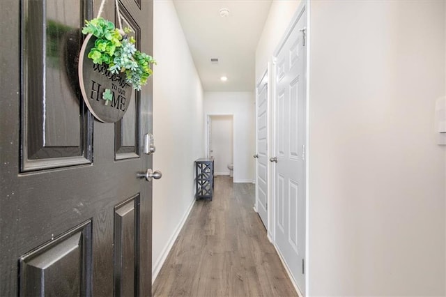 hall with light hardwood / wood-style flooring