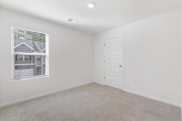 empty room featuring light carpet