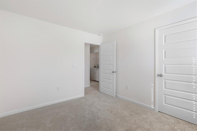 unfurnished room featuring light carpet